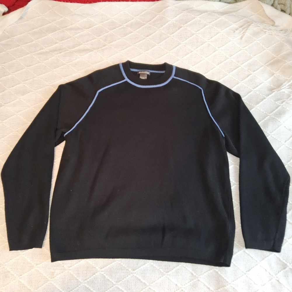 This is a black cotton sweater with light blue piping and a "Pandemonium" tag.